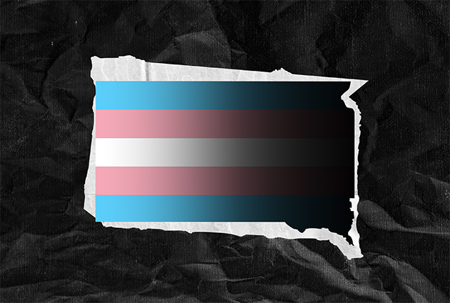 A transgender flag covers the state of South Dakota against a crumpled paper background.