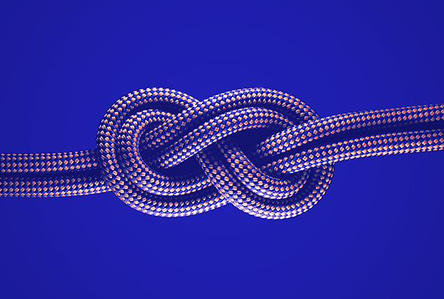 A rope is tied in a figure 8 knot against a blue background.