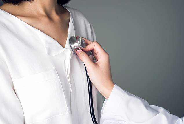 a stethoscope is held over the chest of someone in a white shirt