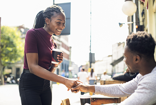 a man and a woman on a first date shake hands 