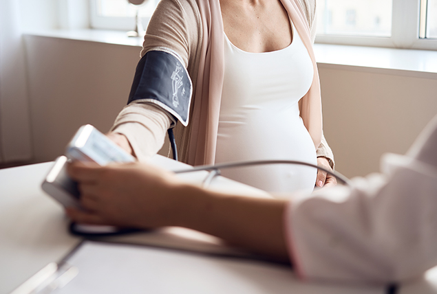 A pregnant woman has her blood pressure taken.