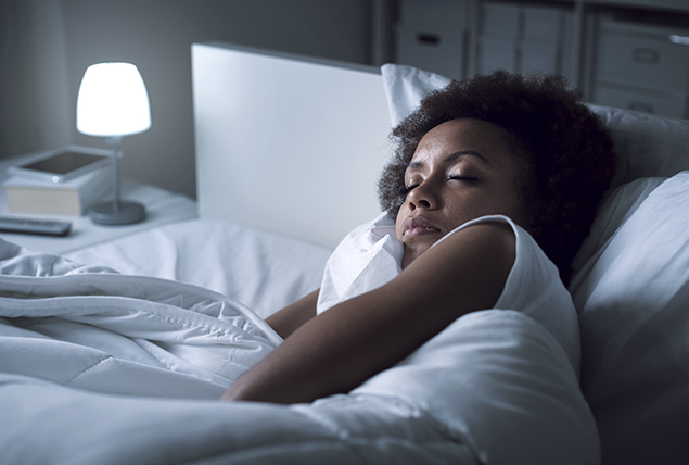 a woman sleeps soundly, clutching a white pillow