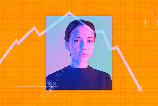 woman looks into camera with a orange line chart background pointing down