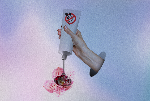 A hand squeezes a bottle of gel that is anti-sperm onto a flower.