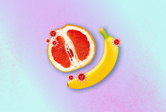 banana and grapefruit with red virus spots on mint and purple background