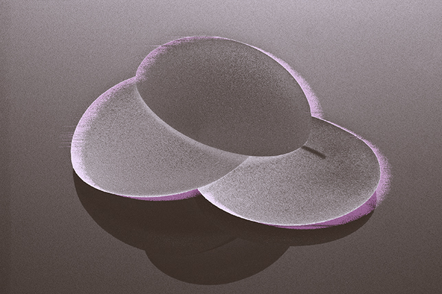 Three breast implants are stacked on top of each other.