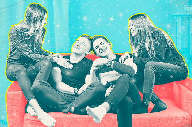 four young adults sitting and laughing on a red couch on a blue background