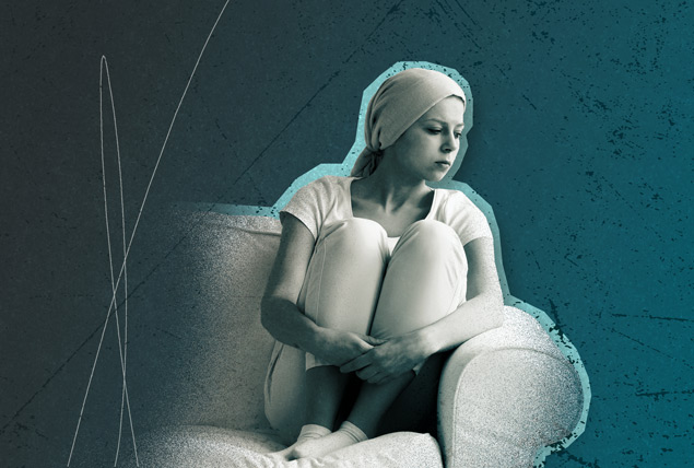 woman in headscarf sits on chair with her knees up looking stressed