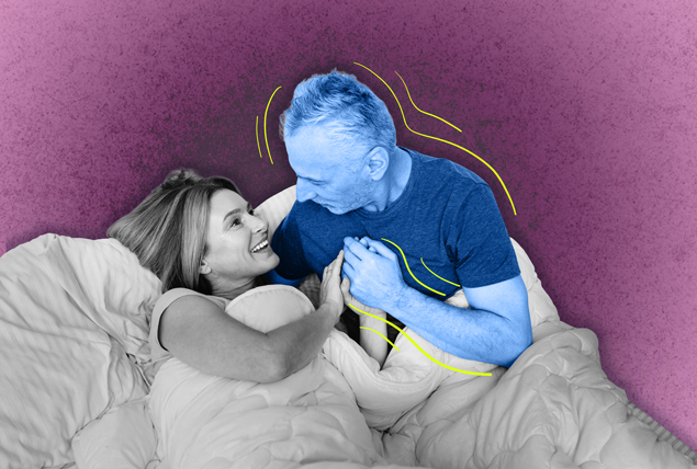 A blue man with Parkinsons Disease lays next to his partner in bed.