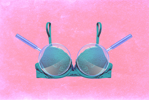 a teal lacy bra with two magnifying glasses over each cup on a pink background