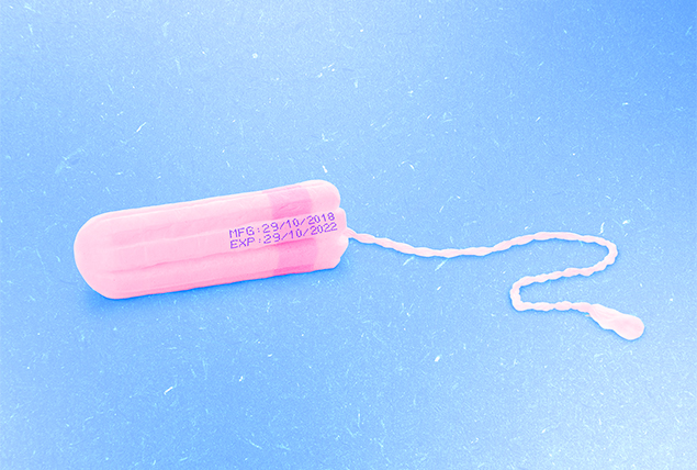 pink tampon with purple expiration date printed on it on light blue background