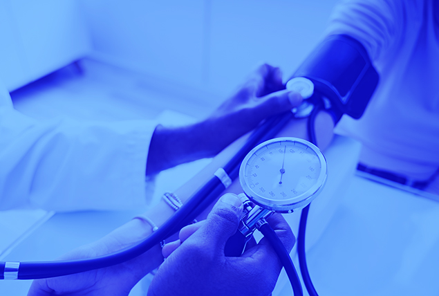 hands taking blood pressure of patient with a blue tint