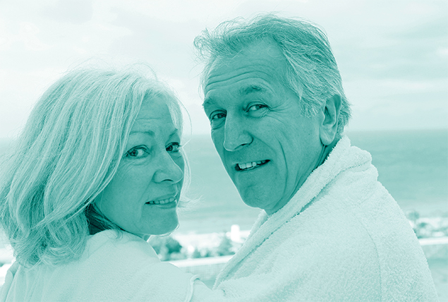 A couple in their 60s look towards the camera with a teal hue overlay.