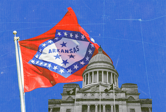 The Alabama state flag is flying on a post near the state house.