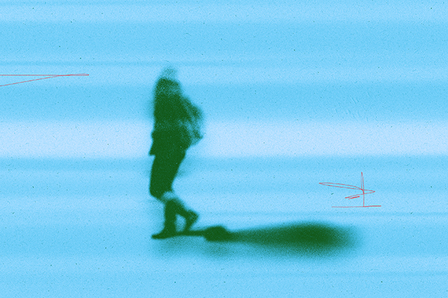 A blurry figure walks along a streaky blue background.