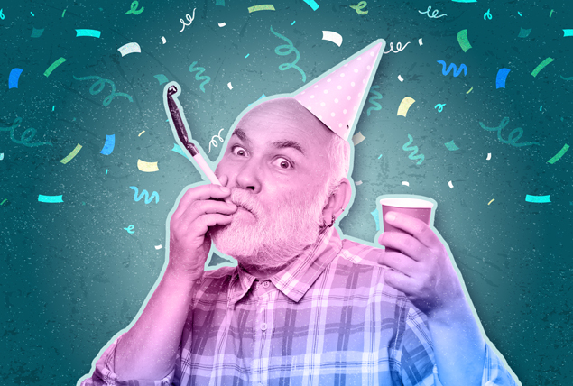 An older man blows a birthday party favor while having a birthday hat on his head as confetti falls around him.