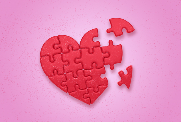 red heart made of puzzle pieces being put together on pink background