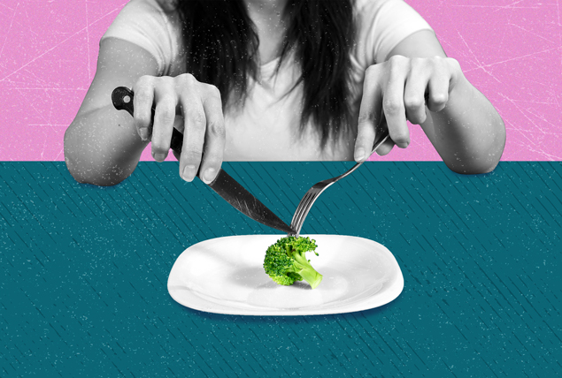 grayscale woman sits at teal table and picks with fork and knife on single green broccoli piece on white plate on a pink background