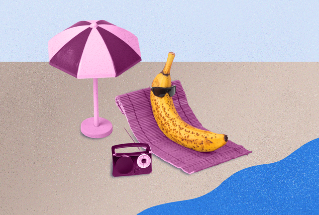 A banana in sunglasses lays on a towel at the beach next to an umbrella and radio.