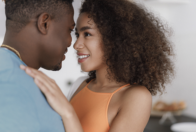 woman and man hold each other close and look deep into each others eyes