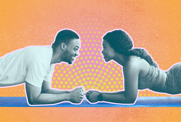 man and woman in plank positions on yoga mats face each other and smile