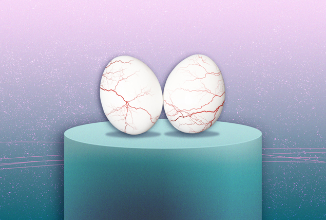 two veiny eggs sitting on blue pedestal on purple background