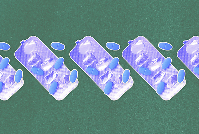 Packets of blue pills are lined up in a row against a green background.