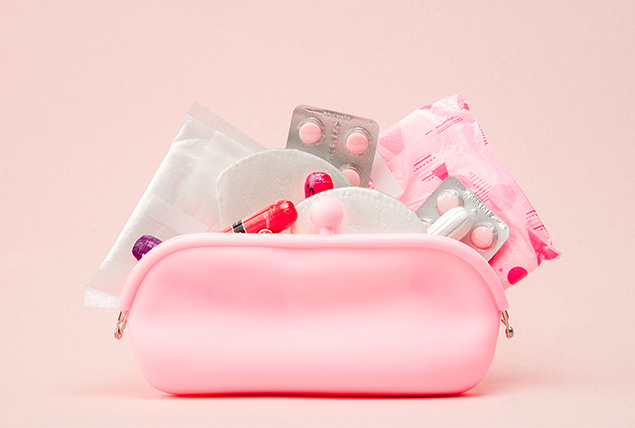 A pink pouch holds various menstrual products.