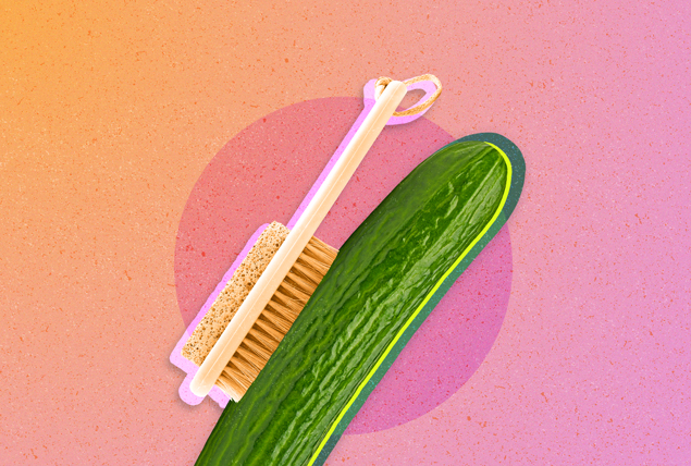 An exfoliation brush rubs against a green cucumber.