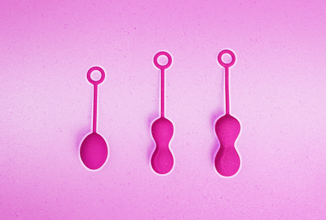 three sizes of pink Kegel balls on pink background