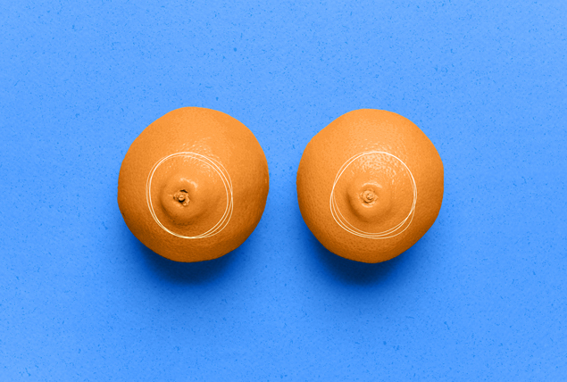 two oranges with navels pointed out circled in white with blue backgrounbd