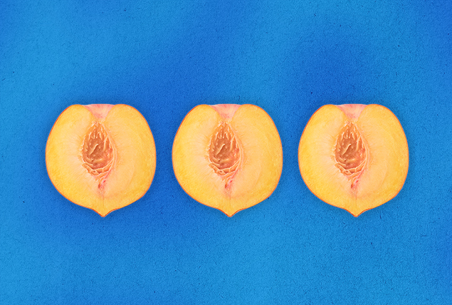 Three open-faced peach halves are in a row against a blue background.