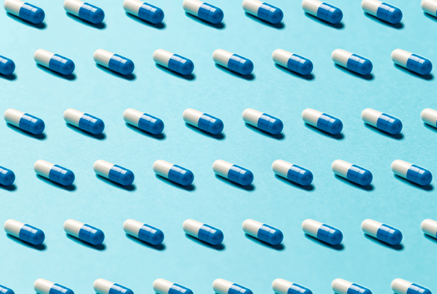 blue and white pills on light blue background