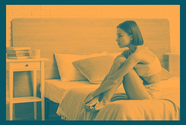 A woman sits on a her bed with an orangish-yellow overlay.