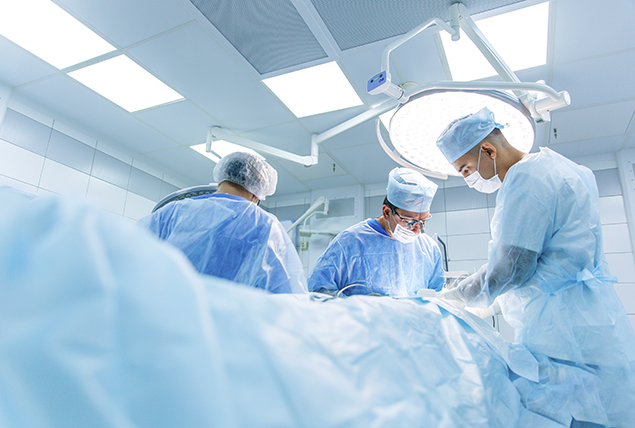 A surgical team works on a woman with pelvic congestion syndrome.