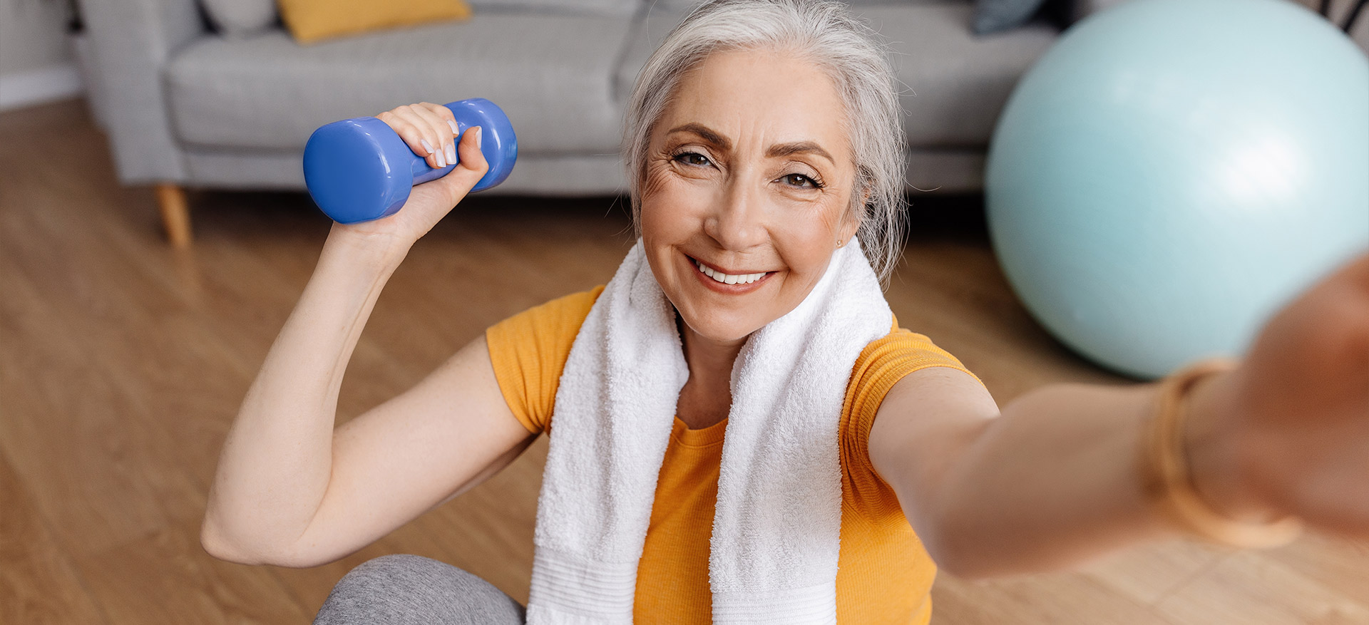 An-older-woman-holds-a-small-weight