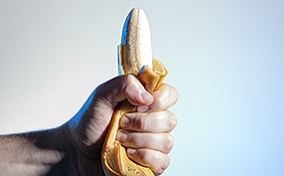 A hand demonstrating death grip syndrome on a banana.
