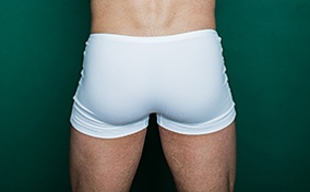 A masculine backside wearing white underwear.
