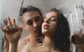 A couple trying a shower sex position for menstrual cramps.