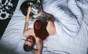 dog in bedroom with couple