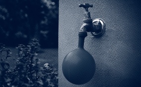 A water tap fills up a water balloon.