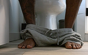 Pants around someone's ankles while they poop.