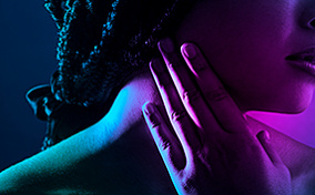 A woman pressing her hand against her sore throat after oral sex.