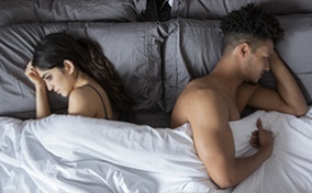 Two people in bed experiencing a dry spell.