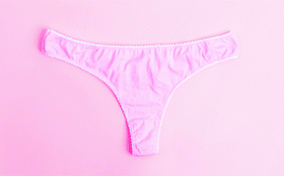 Pink panties on a pink background with red droplets.