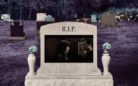 A steamy movie scene plays on a tombstone.