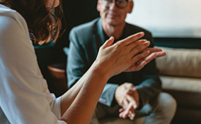 Two-people-sitting-in-a-living-room-staging-an-intervention