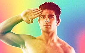 Shirtless-man-soluting-in-front-of-a-rainbow-background