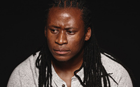 A man stares off to the side looking concerned and in thought.