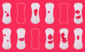 Twelve-menstrual-pads-in-two-horizontal-rows-some-with-red-blood-spots